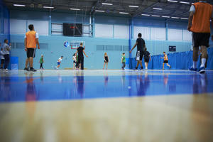 Students playing sports in a sports hall