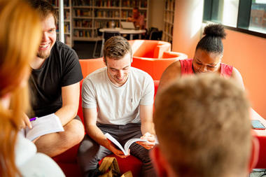 Group of students sitting together and laughing