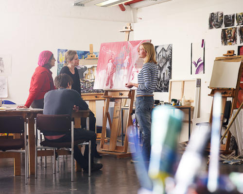 Students gathered around artwork in Garage Studios
