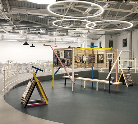 a well lit and sparsely-populated art gallery