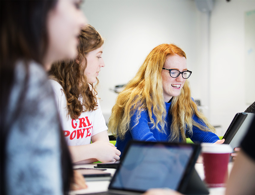 Students in a classroom working on tablets