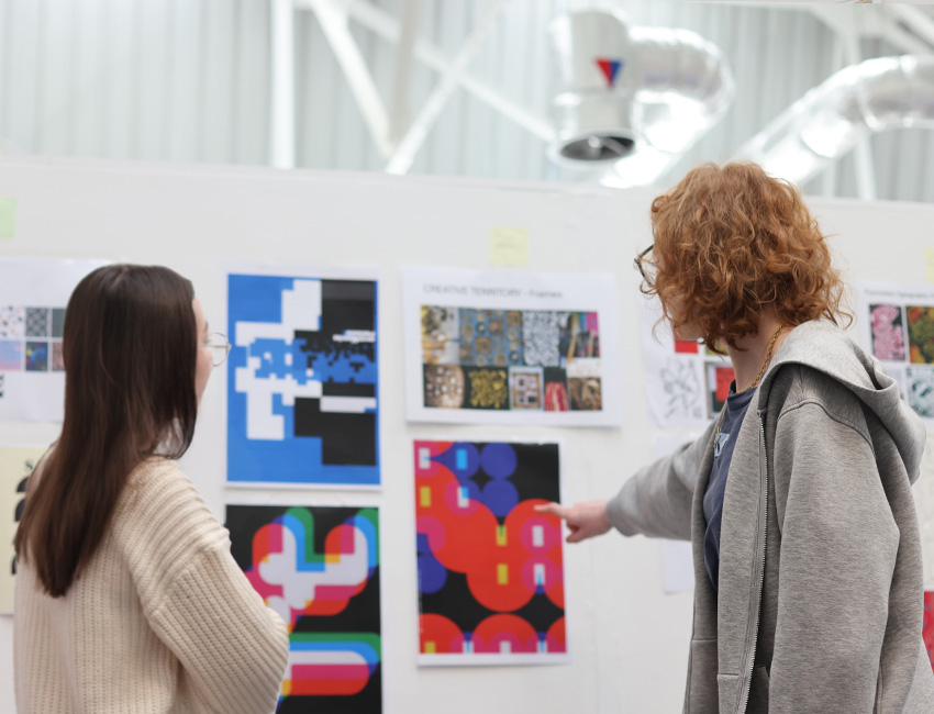 Two graphic design students discussing designs