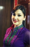 woman in a purple top and long dark hair