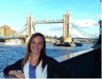 young woman standing in front of london bridge