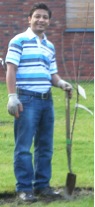 man in a striped shirt holding a spade