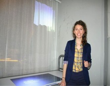 young woman in a yellow check shirt and blue jacket