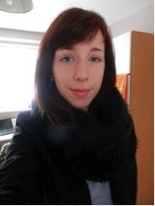 young woman with brown hair and wearing a dark jacket