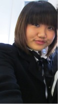 young woman in a dark top and bobbed brown hair