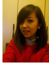 young woman in a red top shoulder with shoulder length brown hair