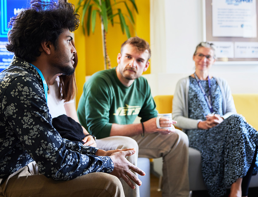 Students sat on sofas listening as one student shares their thoughts