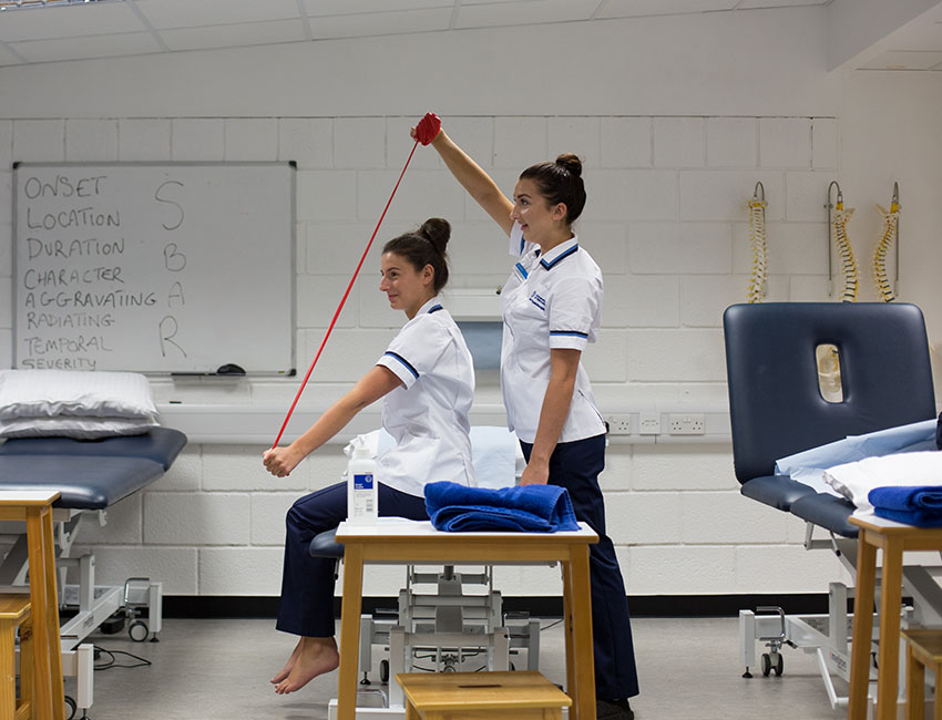 Two girls engaging with a physiotherapy task