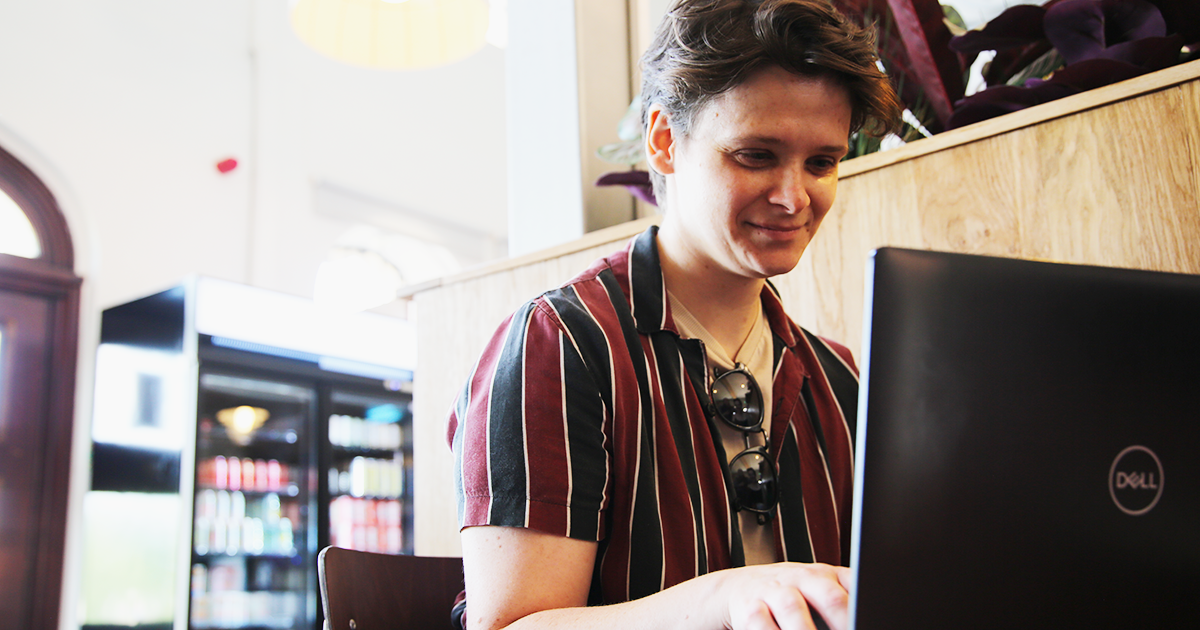 Student in a cafe working on a laptop