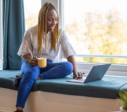 A student working on a laptop while at home