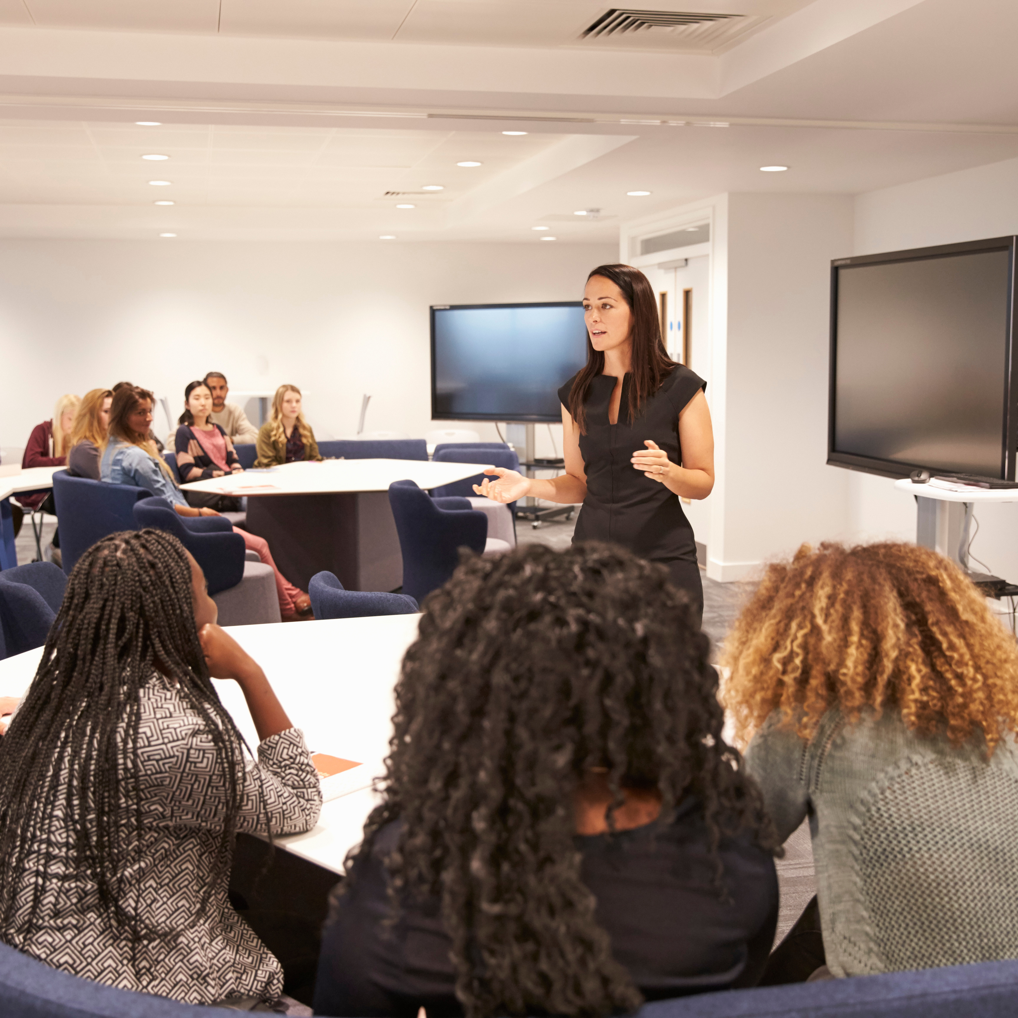 Woman giving lecture to students