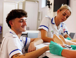 Male nurse practicing blood pressure reading