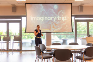 A presenter delivering a talk for the PGR Conference