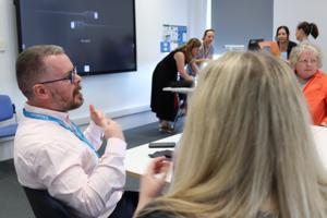 A group of people sat around a table talking