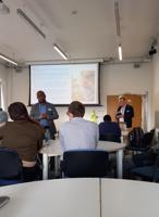 A speaker delivering a talk to a room of people