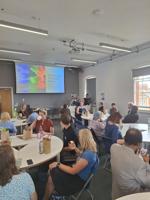 A group of conference delegates around circular tables