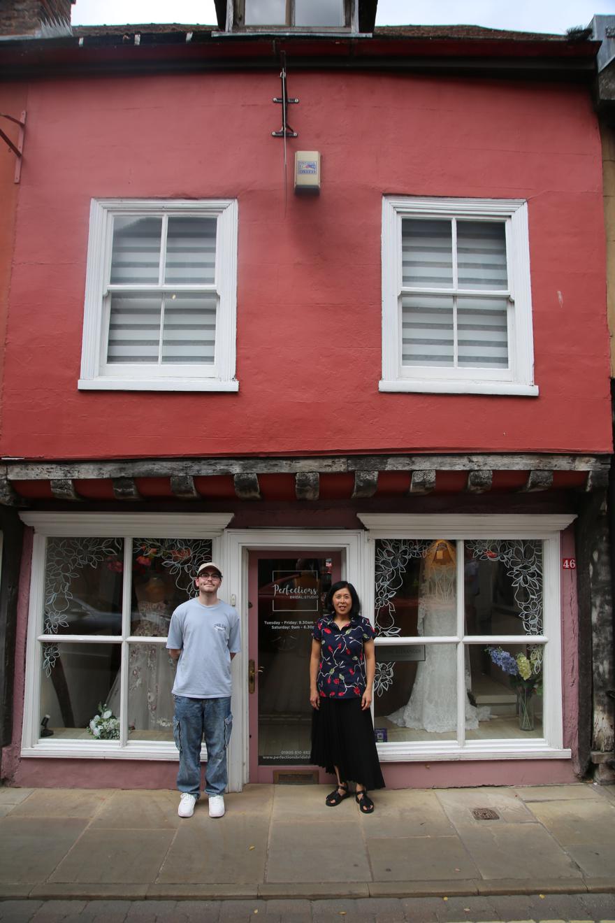 two people pose outside an old building in Worcester