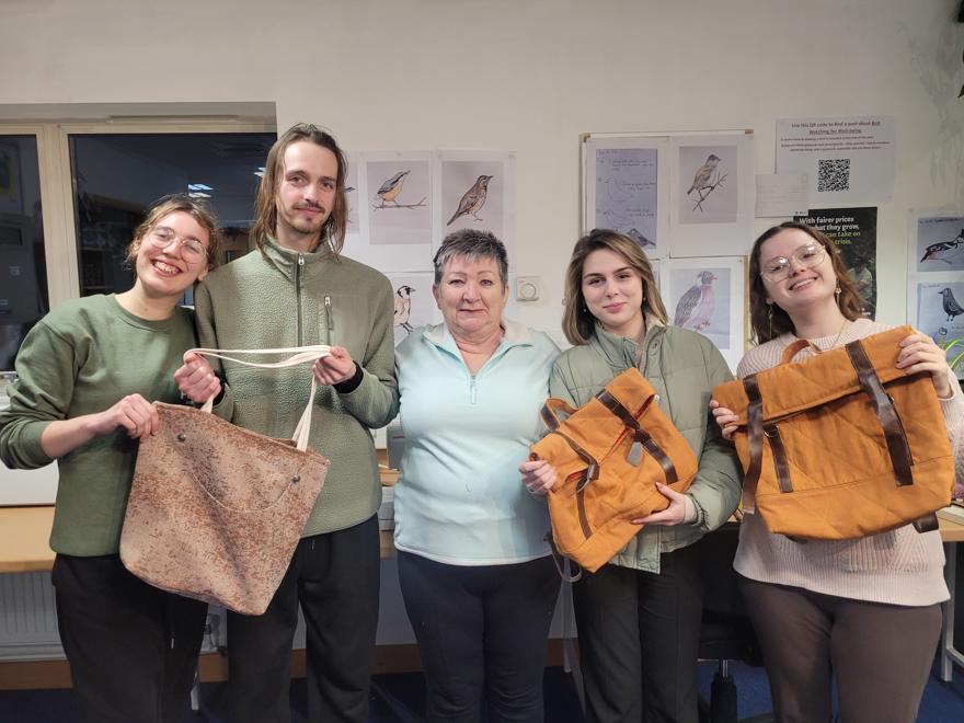 Students holding the bags they've made