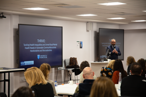 Professor John Paul Wilson delivers a speech to the attendees