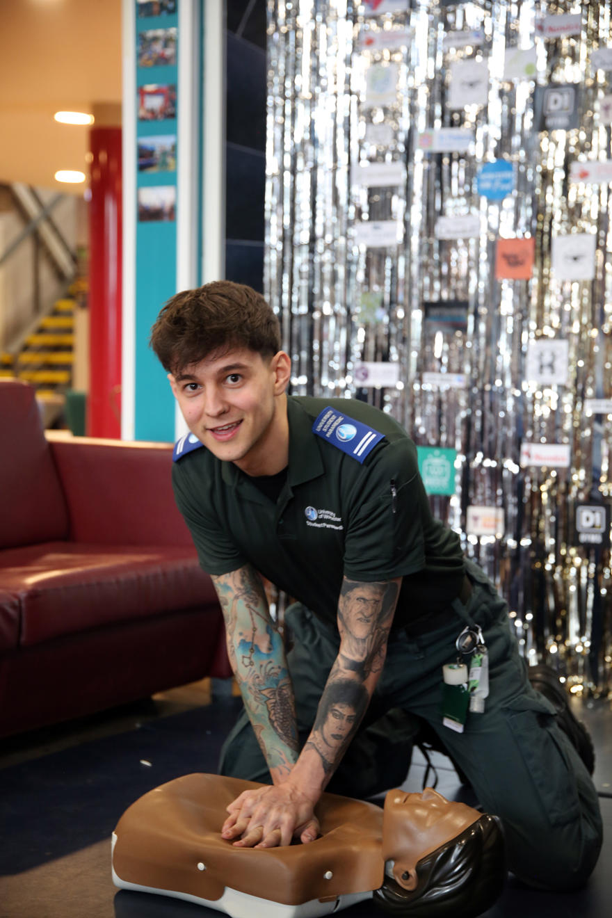 Dylan Stephenson performs CPR on a dummy