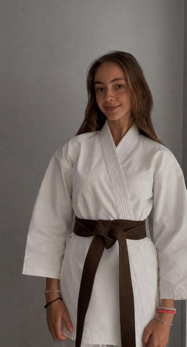 UW Lina Makazlieva poses in her karate uniform with a brown belt