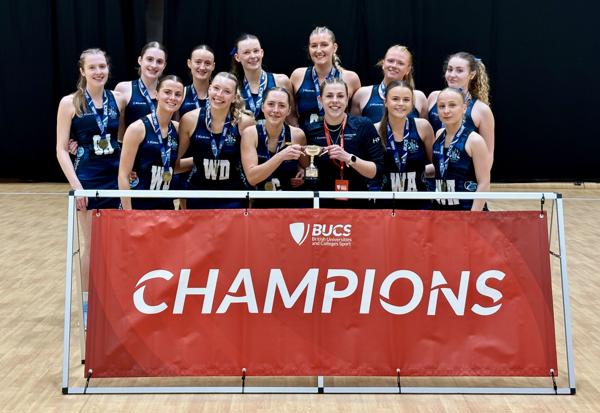 Victorious Worcester team stands in front of a banner which reads 'champions'