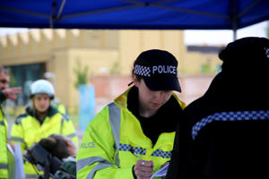 A student police officer takes details from a crash casualty actor
