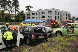 Paramedics tend to a wounded person in a car
