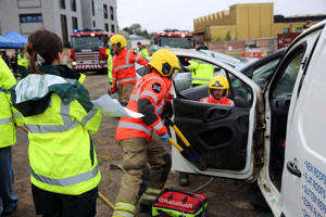 Firefighters remove the door of a van to extract the occupant