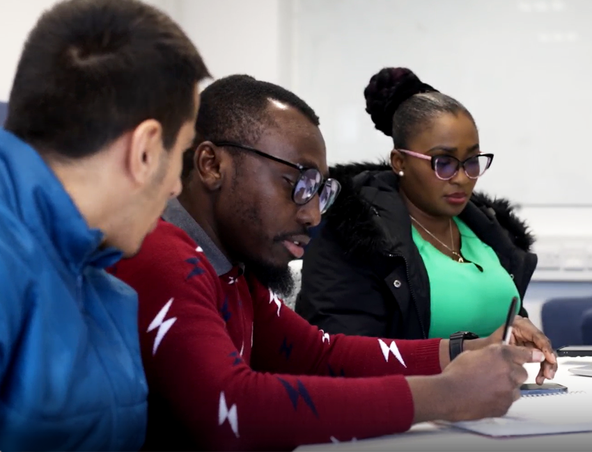 3 students making notes together