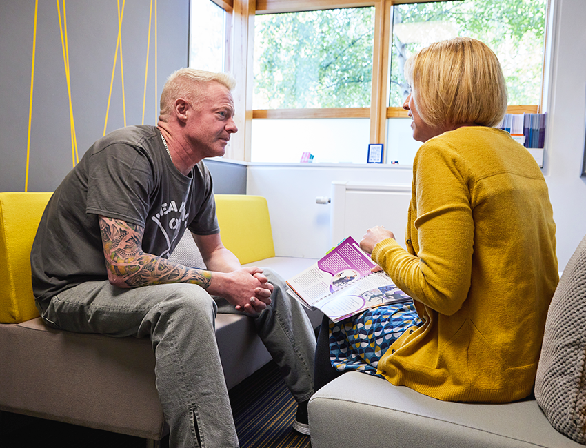 Mature student speaking with a mental health advisor