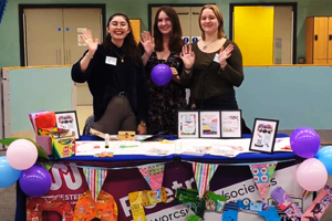 Students stood behind a colourful poetry stall