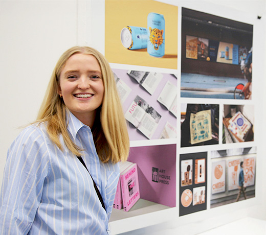 Graphic Design student Lois exhibiting her work at the Art Degree Show