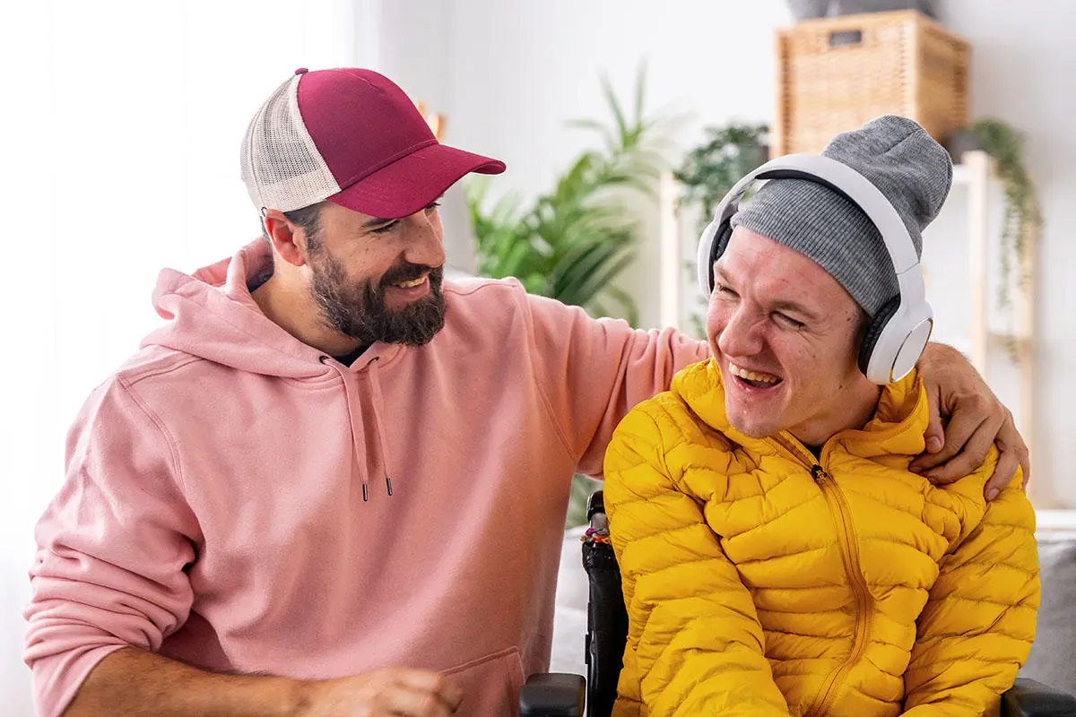 Carer and disabled man in music therapy session