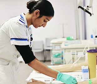 a nursing student working with the practical equipment