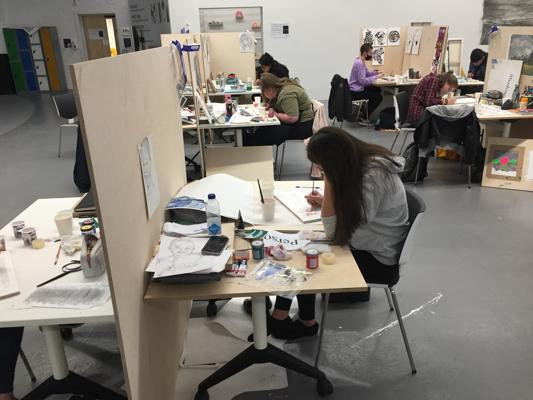 A group of students working on easels