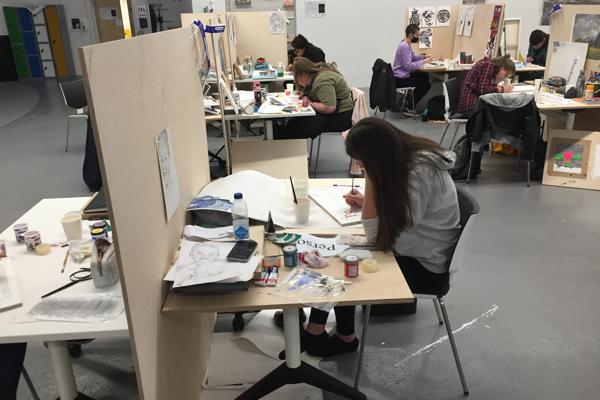 A group of students working on easels