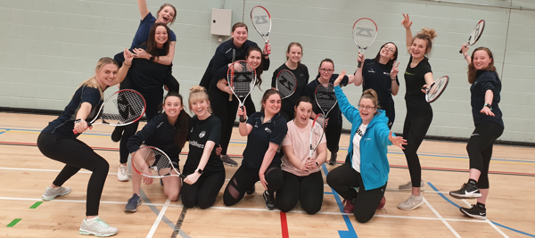 PGCE Secondary PE students posing together holding tennis rackets