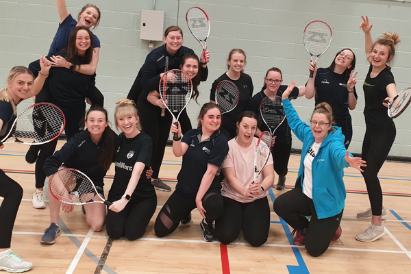 PGCE Secondary PE students posing together holding tennis rackets