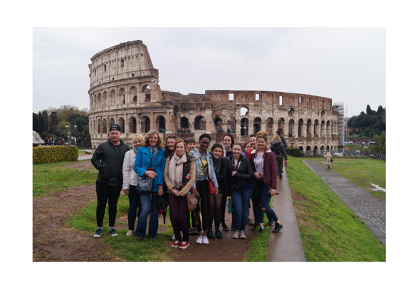 Students pose in front of the Colosseum