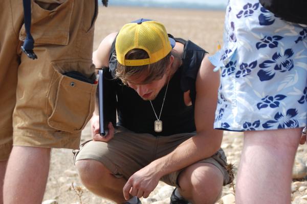 student in a yellow cap looking downwards