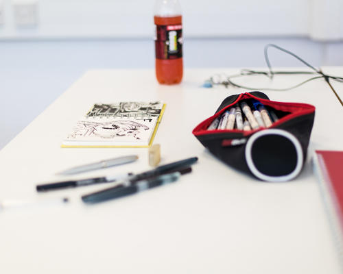 Open pencil case and doodle on pad