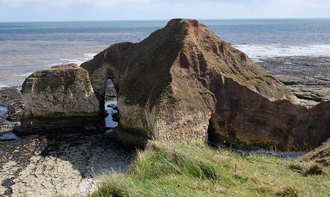 View of rocky outcrop with sea behind