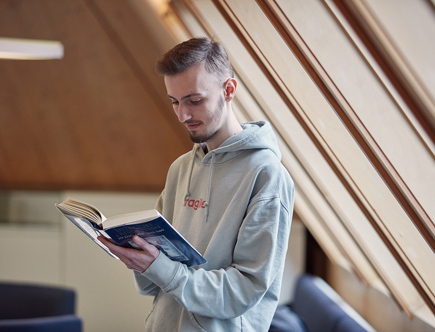 An English Literature student reading in The Hive Library