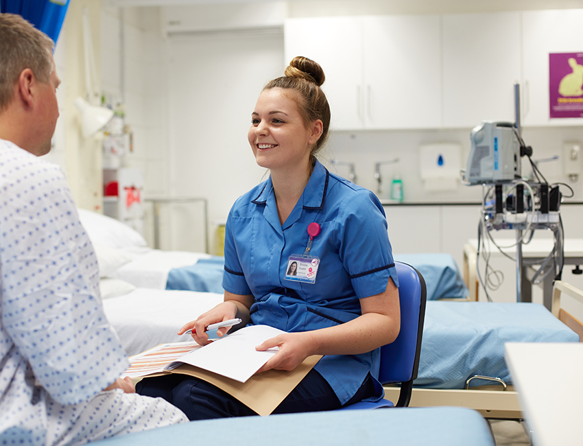 Nurse speaking with patient at the bedside