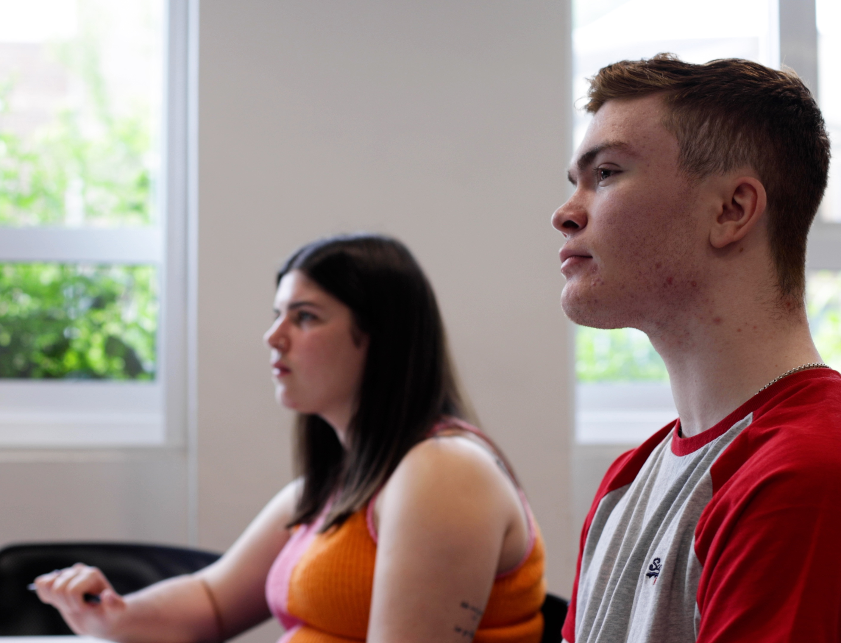 Two students listening to a lecture