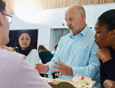 Man talking to group of students